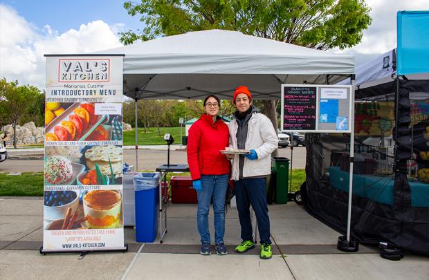 Val's Kitchen owner in the Dublin Farmers Market standing in front of their stall