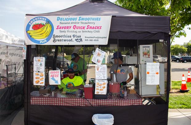 Picture of smoothies plus workers inside stall