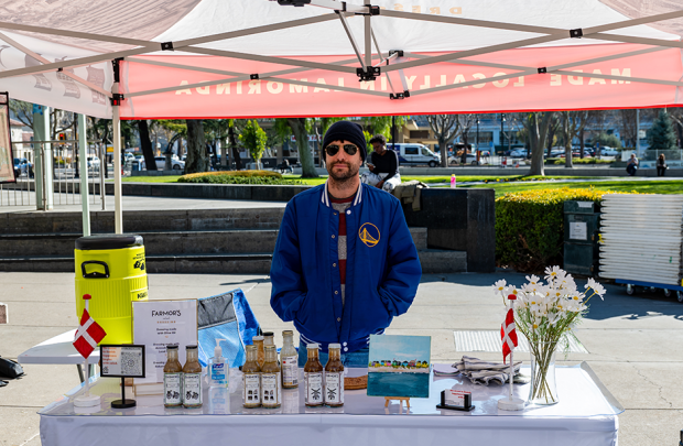 Vendor selling at the Farmor's Dressing stall at the farmers' market 