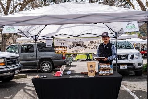 A seller at the Alldrin Bros stall at the Danville Farmers' Market