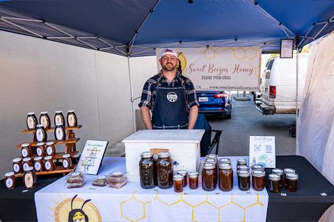 The owner of Sweet Beezus honey at their booth at the Pinole Farmers' Market