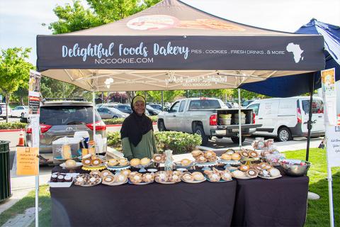 Delightful Foods smiling in booth surrounded by goods