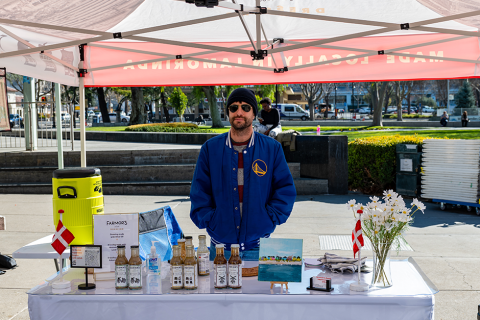 Vendor selling at the Farmor's Dressing stall at the farmers' market 