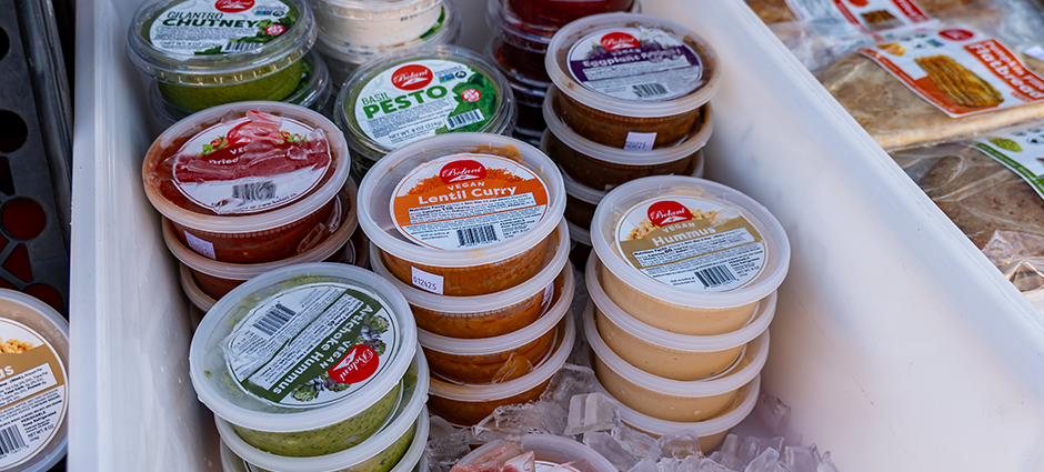 Various dips inside a cooler with ice