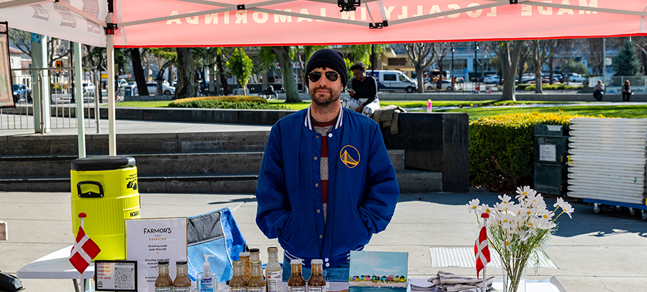 Vendor selling at the Farmor's Dressing stall at the farmers' market 