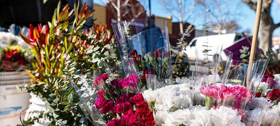 Sunrise Nursery stall at the market, with blooming bouquets of flowers in buckets